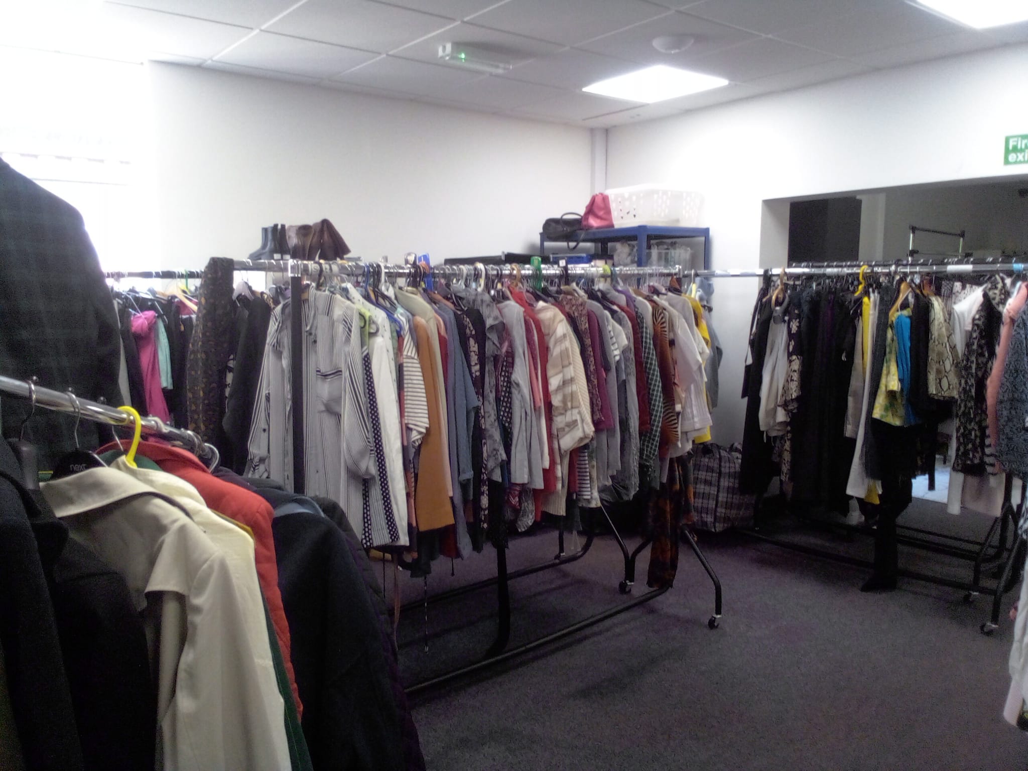 Long rails of women's clothing, sorted and hung up ready to choose from.